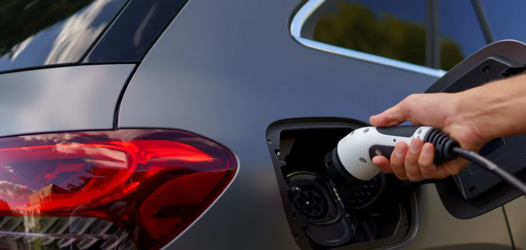 man holding power supply cable at electric vehicle 2022 11 11 00 41 26 utc terra-energys.de